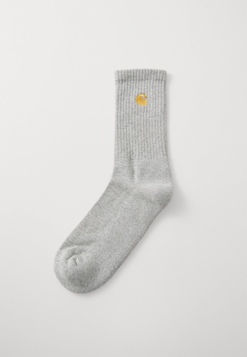 Gray ribbed sock with a rounded toe and a yellow emblem, featuring a casual design suited for everyday wear.