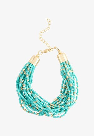 Multi-strand bracelet with small turquoise and gold beads, gold-tone caps, and adjustable gold chain clasp.
