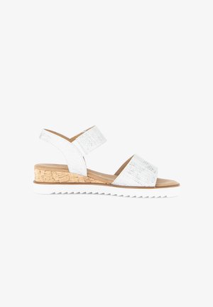 White woven two-strap sandal with cork wedge heel and white ridged sole, open toe, and adjustable back strap.