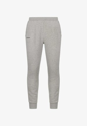 Pantaloni della tuta grigi in tessuto morbido, con design a gamba affusolata, vita elastica, tasche laterali e un piccolo logo nero sulla coscia sinistra.