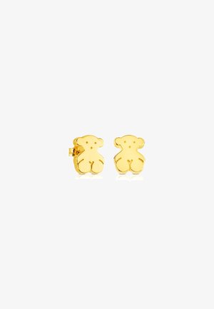 Boucles d'oreilles en forme d'ours en or avec une finition polie, présentant des bords arrondis et de petits détails faciaux. Construction durable et clip de sécurité.