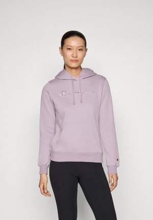 Lilac hoodie with a front pocket, drawstring hood, and embroidered "Champion" logo. Fabric appears soft and slightly textured.