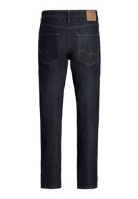 Tumesinised teksad, valmistatud teksariidest, sirge lõikega, kuldsete õmblustega, kahe tagataskuga ja vööaugu kohal nahast brändiplaadiga.