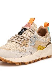 Beige and gray sneaker with mixed materials, featuring a textured upper, colorful accents, round laces, and a rugged rubber sole.