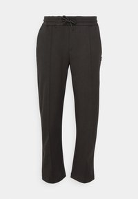Schwarze, lässig geschnittene Hosen mit einem elastischen Bund, Kordelzug, Seitennähten und glatter Textur. Keine sichtbaren Taschen.