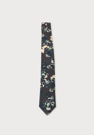 Σκούρα γραβάτα με floral μοτίβο σε αποχρώσεις του τυρκουάζ, του ναυτικού μπλε και του μπεζ, παρουσιάζεται επίπεδη σε ανοιχτό γκρι φόντο.
