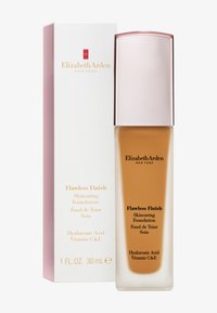 Flacon de fond de teint Flawless Finish avec un fond transparent et un liquide beige, présenté dans une boîte rose pâle avec du texte et un logo dorés.