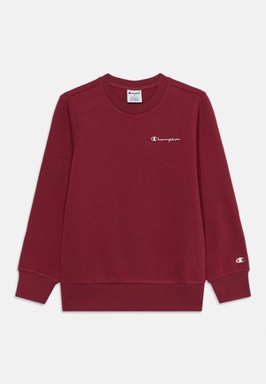 Bluza bordowa z długim rękawem i okrągłym dekoltem, z małym białym logo Champion na lewej piersi i mankiecie rękawa.