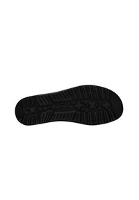 Suela de zapato de goma negra con una superficie texturizada, que presenta un patrón de aristas y formas de estrella para agarre y tracción.