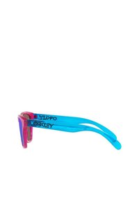 Blue and pink sunglasses with a transparent frame, featuring a large lens shape and bold branding on the arms. Smooth texture, modern design.