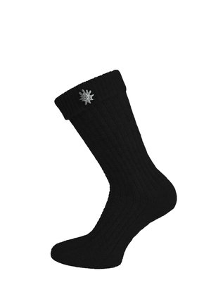 Black ribbed knee-high sock with a folded cuff and a small silver flower-shaped emblem on the outer side near the top.