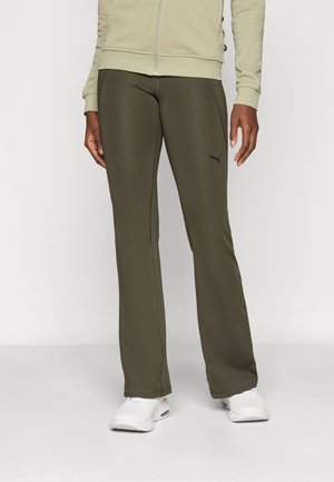 Olive green athletic pants with a fitted design, featuring a black logo on the thigh and smooth, stretchy fabric. Paired with white sneakers.