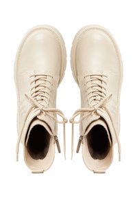 Beige nahka nilkkurit pyöreillä reunoilla, etulangoilla ja sivuvetoketjuilla. Teksturoitu vuori ja kumipohjat.