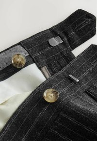 Gray wool blend trousers featuring a pinstripe pattern, metal hook closure, and tan buttons; textured fabric with smooth lining.