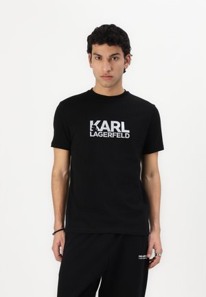 Svart bomull T-skjorte med en dristig hvit "KARL LAGERFELD" logo, rund hals, korte ermer og en avslappet passform.