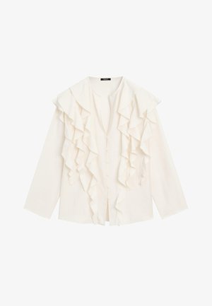 Krämfärgad blus med lång ärm, detaljerad med lager av rynkor framtill och tygklädda knappar längs mitten.