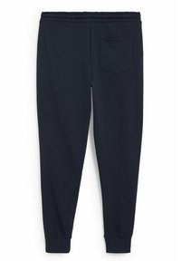 Tummansinisiä collegehousuja, jotka on valmistettu pehmeästä kankaasta. Niissä on joustava vyötärö, kapenevat lahkeet ja pieni takatasku.