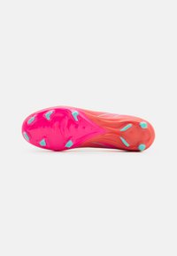 Football cleat with a bright pink smooth sole, featuring turquoise studs and stripe accents. Lightweight design for performance.