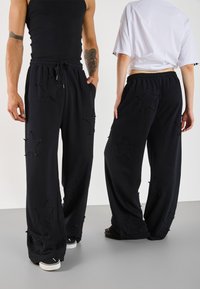 YOURTURN UNISEX - Teplákové kalhoty - black