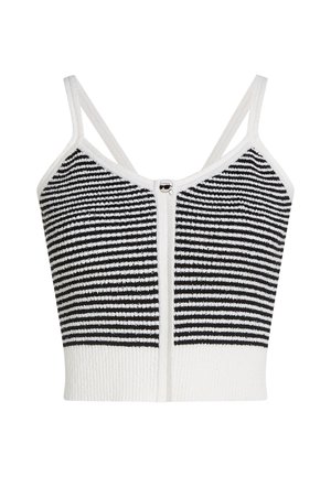 Triibuline kärbitud topp, mis on valmistatud mustast ja valgest kootud materjalist, reguleeritavate rihmade ja esiküljel asuva ümarate metallaktsentidega lukuga.