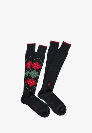 Calze al ginocchio in cotone nero con dettagli rossi. Una coppia presenta un motivo argyle in rosso e verde, mentre l'altra è di un nero uniforme.