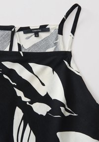 Schwarz-weiße gemusterte Camisole aus weichem Stoff, mit dünnen Trägern und einem Etikett mit der Aufschrift "someday" in Größe 36.