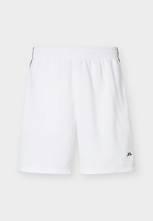 Beli športni kratki hlače do kolen z elastičnim pasom in majhnim črnim logotipom na spodnjem levem delu noge na enobarvnem ozadju.