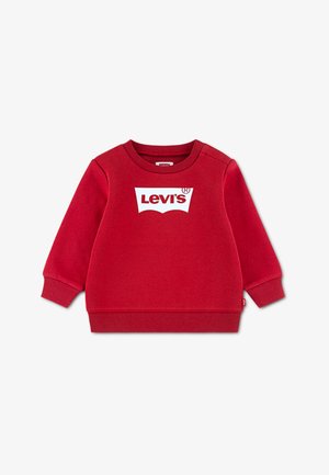 Sarkans džemperis no kokvilnas maisījuma ar garām piedurknēm. Priekšpusē ir balts Levi's logotips, kā arī ribots apakšmala un aproces.