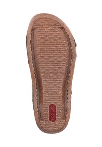 Brown rubber sole with a textured, ridged surface. Features a circular logo in red. Edge is stitched for durability.