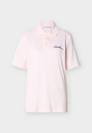 Jasnoróżowa koszulka polo z krótkim rękawem, kołnierzykiem, dwoma guzikami oraz czarnym podpisem "Lacoste" na lewej piersi.