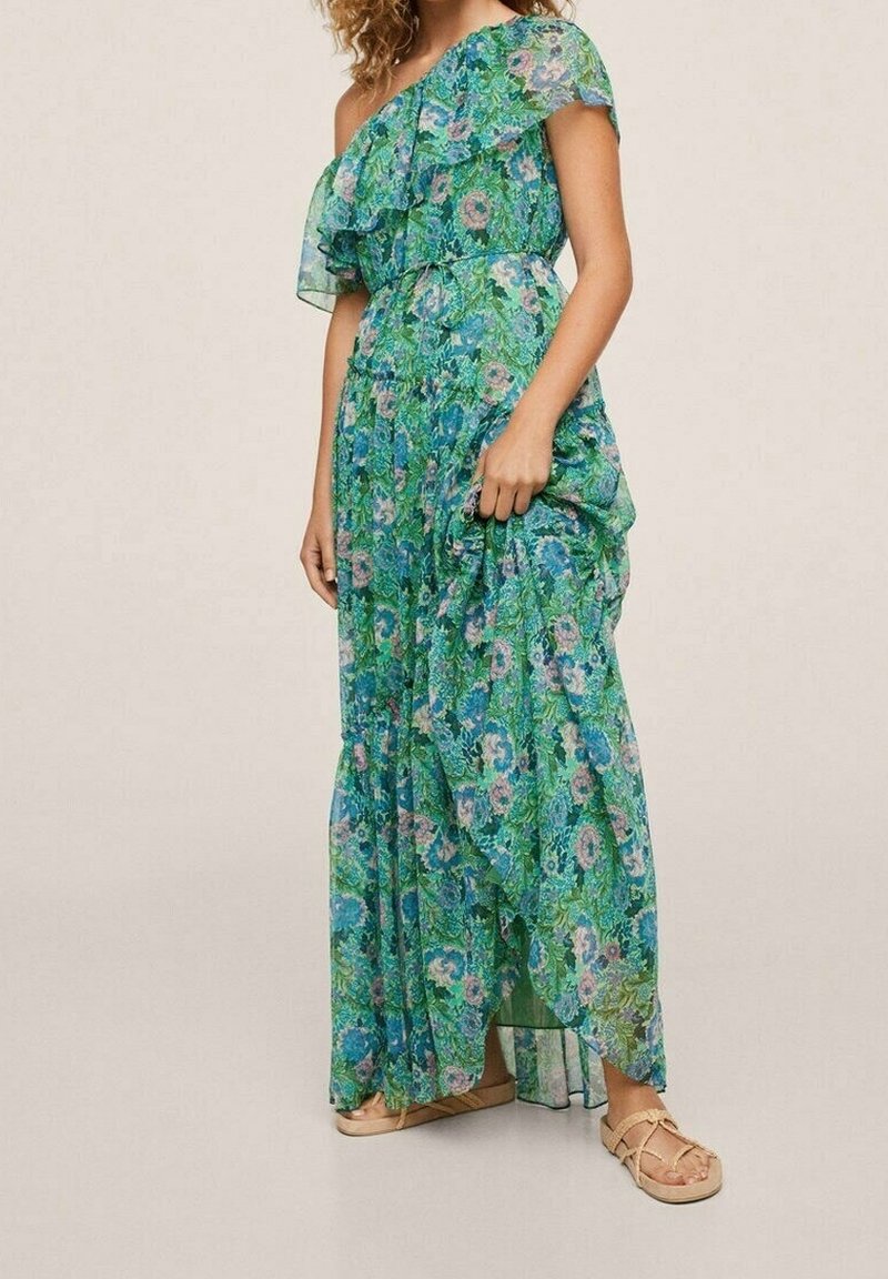 Maxi dress in green chiffon with floral print, featuring an off-shoulder design, ruffled overlay, and a slightly asymmetrical hemline.