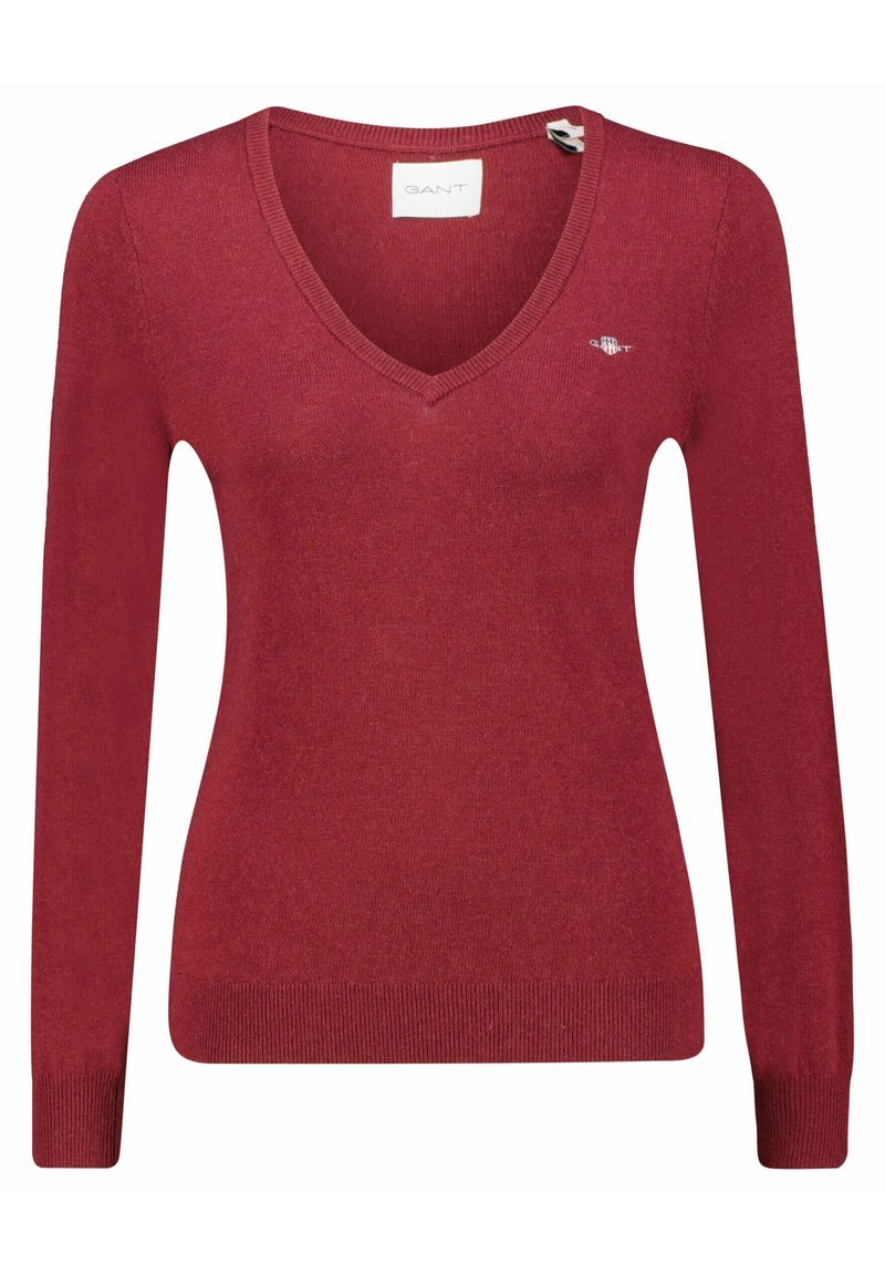 Maglione rosso a maglia con scollo a V e maniche lunghe. Presenta un logo sul petto e polsini e orlo a coste. Texture morbida, design aderente.