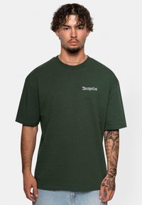 Mørkegrøn bomulds T-shirt med korte ærmer, der har teksten "Dropsize" i hvid på brystet. Casual fit og glat tekstur.