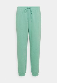 Mintgroene joggers gemaakt van zacht materiaal, met een elastische tailleband met trekkoord, cuffs aan de enkels en zijzakken.