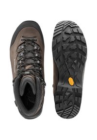 Braune Wanderschuhe mit einer schwarzen Gummischnauze und strukturiertem Vibram-Sohle. Mit Metallösen und robustem Schnürsystem. Weiche Innenauskleidung.