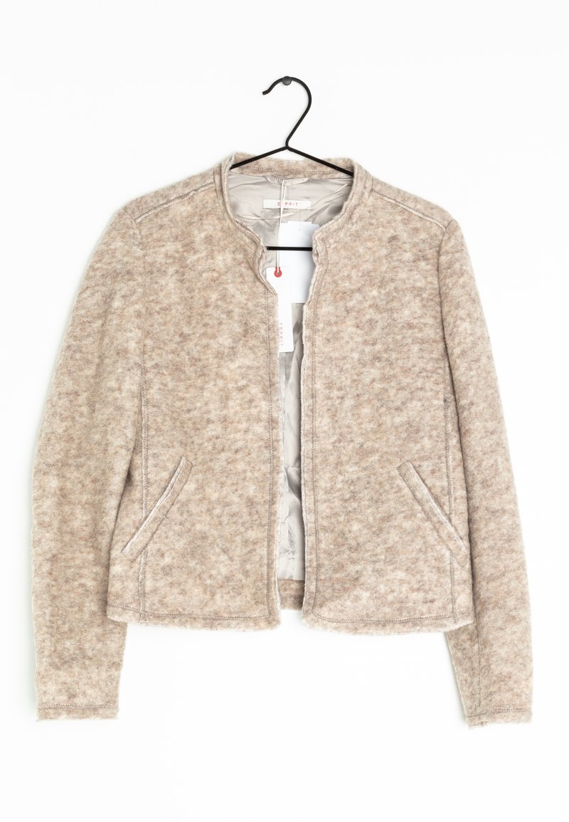 Beige jakke lavet af struktureret stof, med rund halsudskæring, sidelommer foran og en cropped pasform med synlige stikninger.