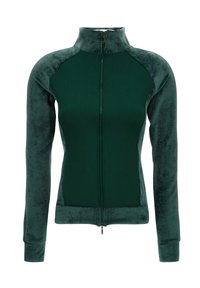 Giacca verde con zip e colletto alto, realizzata in un morbido tessuto testurizzato con lati lisci. Presenta maniche lunghe e un design aderente.