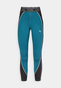 Leggings a vita alta in teal e nero con piping bianco. Presentano il logo Puma sul davanti, realizzati in materiale elastico e sportivo.