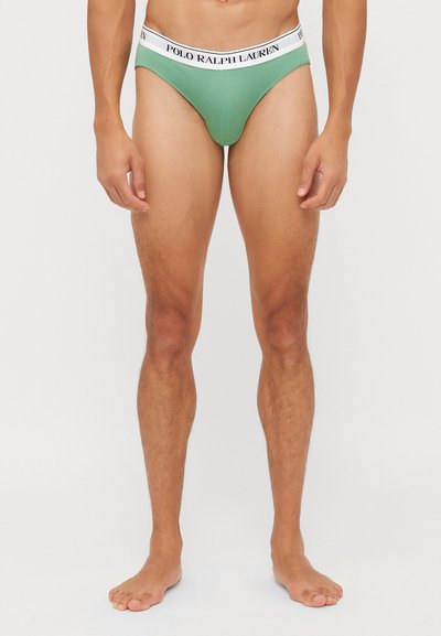 Grüne Herrenunterhosen mit einem kontrastierenden weißen Bund, der mit "POLO RALPH LAUREN" beschriftet ist. Der Stoff wirkt glatt und hat ein enganliegendes Design.