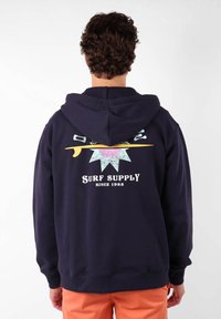 Sweat à capuche bleu marine avec un cordon de serrage et une poche kangourou. Présente un graphique coloré au dos avec "Surf Supply" et un design de soleil.