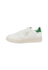 White leather sneaker with green heel accent, flat laces, perforated toe, and gold branding. Features a thick, white rubber sole.