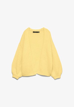 Cardigan jaune tricoté doux et oversize avec ouverture à l'avant et manches bouffantes, présenté à plat sur un fond blanc.