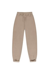 Beżowe dresy z elastycznym paskiem w talii, bocznymi kieszeniami i zwężanymi mankietami. Miękka tkanina o gładkiej strukturze i minimalnej ilości szwów.