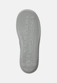 Gray rubber shoe sole featuring an embossed "ENERGIA HUMANA" text, dotted texture for grip, and a circular logo with size 42.