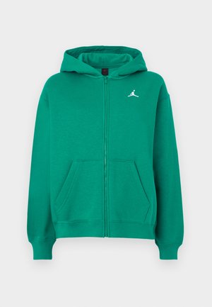 Groene ritsjack met een voorzak, ribgebreide manchetten en onderrand. Bevat een wit logo op de borst. Gemaakt van een zachte, gestructureerde stof.