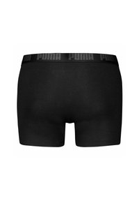 Boxer briefs neri realizzati in un tessuto liscio, con una cintura larga nera con il logo "PUMA" impresso lungo il bordo superiore.