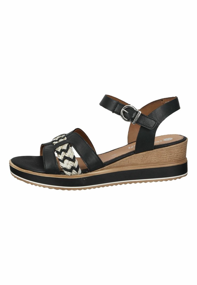 Sandale compensée en cuir noir avec accents tressés crème et noir, bride de cheville réglable, et semelle plateforme texturée.