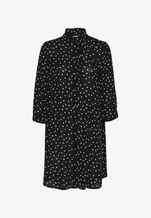 Fekete gombos ruha fehér pöttyökkel, magas gallérral és háromnegyedes ujjakkal. Az elején fodor található, sima textúrával.