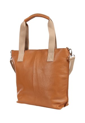 Brown leather tote bag with beige fabric handles and an adjustable shoulder strap against a white background.