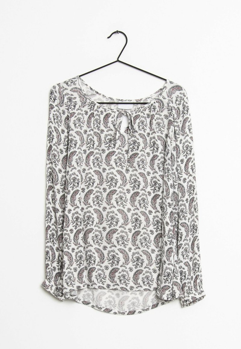 Langärmlige Bluse mit Rundhalsausschnitt und Schlüssellochdetail. Weißer Stoff mit schwarzem und rotem Paisleymuster. Leicht und in fließendem Design.